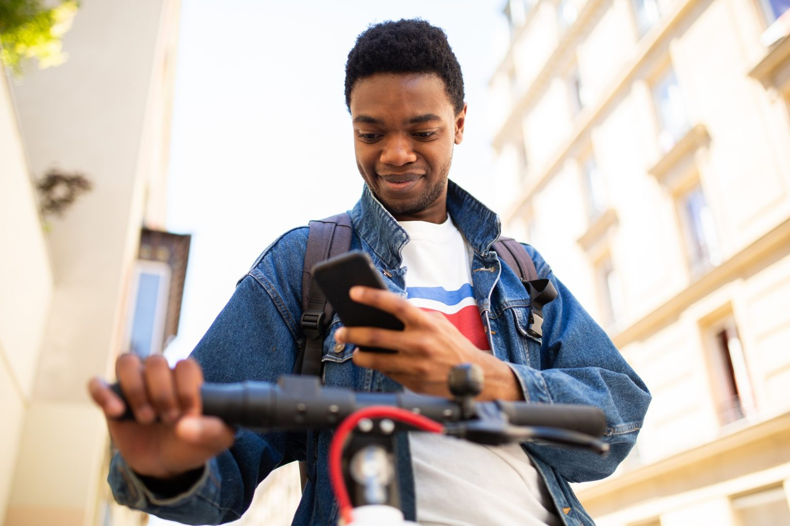Young man checking his phone while commuting